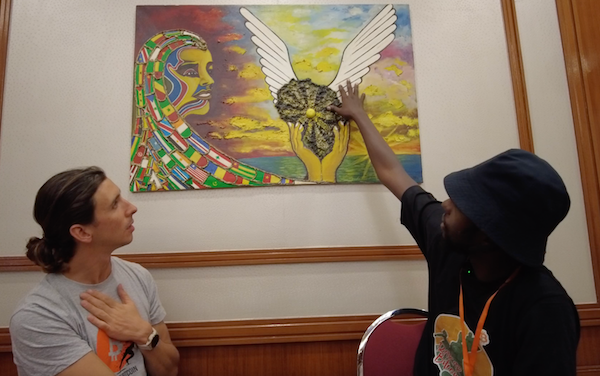 Nourou points to the wings of Africa during an interview