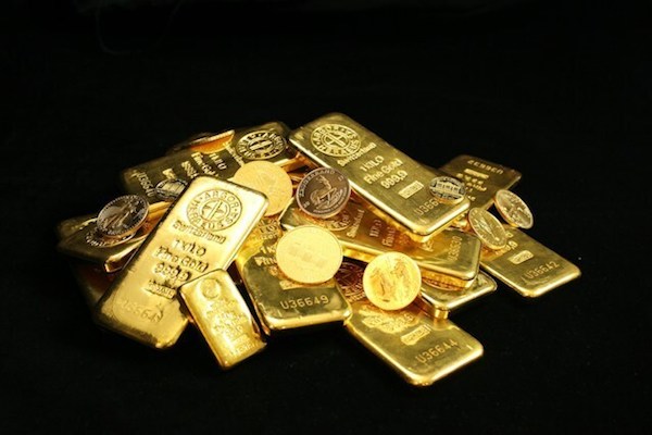 Pile of gold bullion coins and bars from Canada, Australia, U.S. and Krugerrand and others