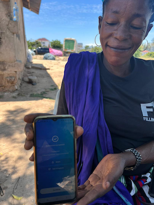 Jane Mago demonstrates the app. Blockchain environmental cleanup